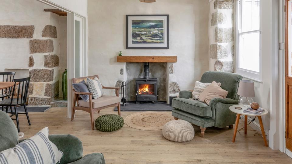Comfortable armchair next to wood burner - perfect cosy corner at Ealing House Porthleven